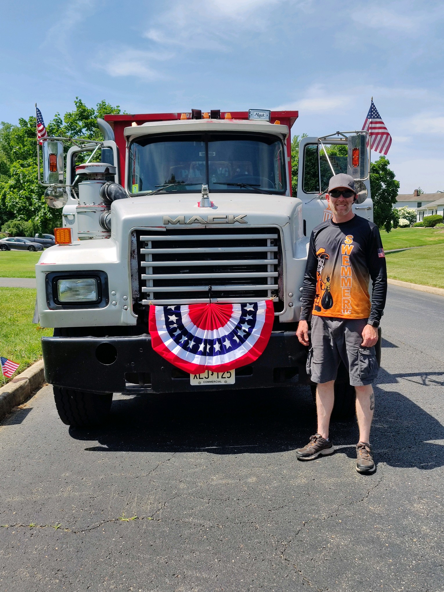 Joe Swemmer, owner of Swemmer Disposal Services, standing next to his Mack dump truck